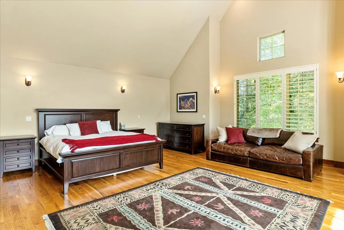 Bedroom featuring high vaulted ceiling and light wood-style flooring
