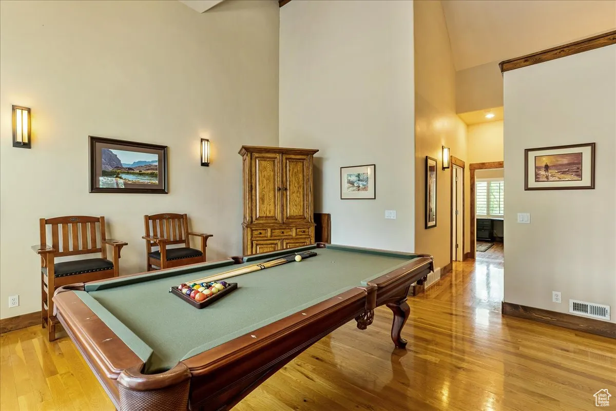 Game room featuring high vaulted ceiling, light wood-type flooring, billiards, and recessed lighting