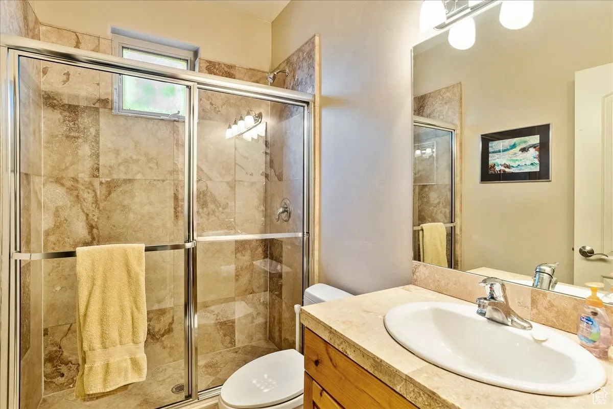 Bathroom featuring vanity and a stall shower