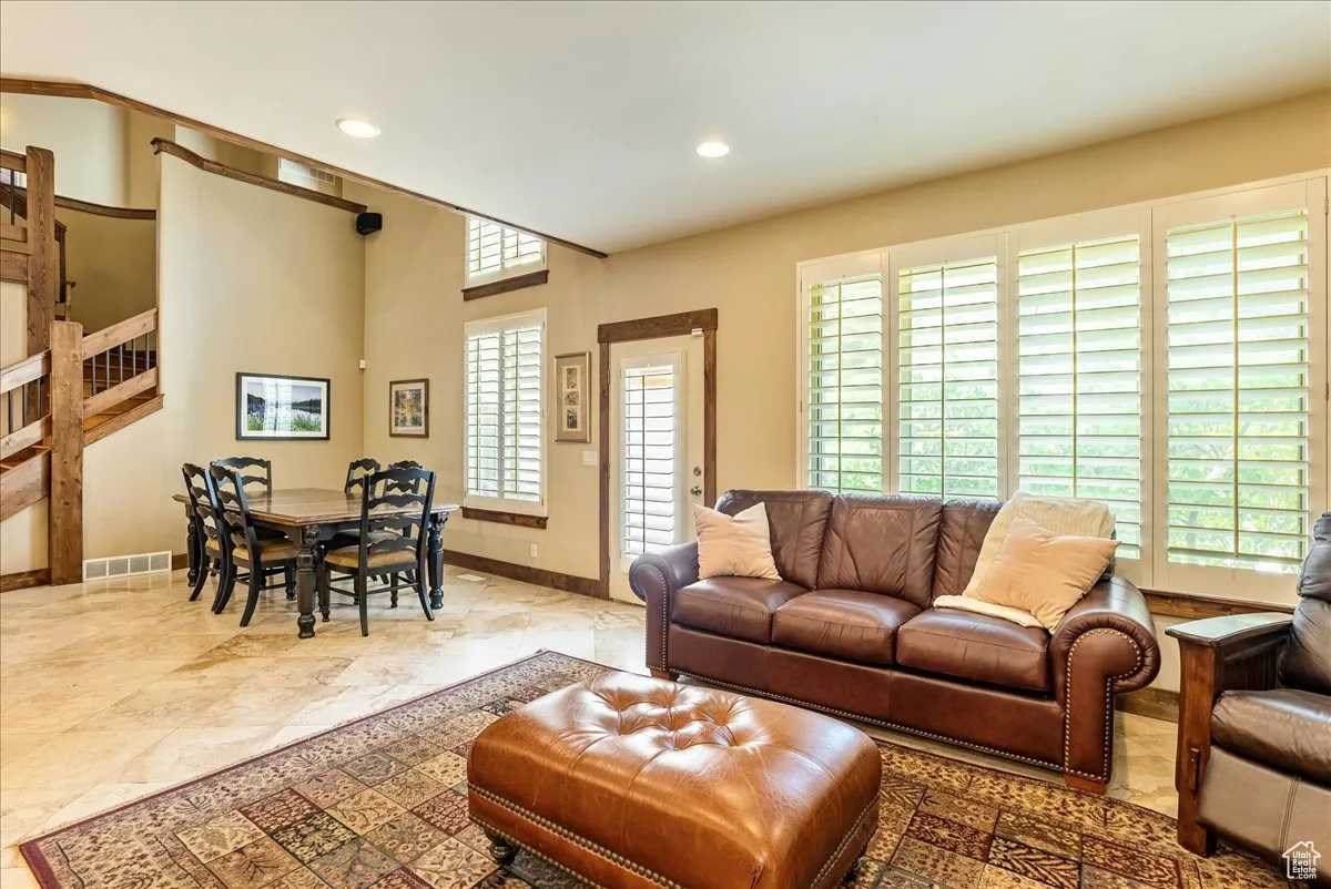Living room with recessed lighting and stairs