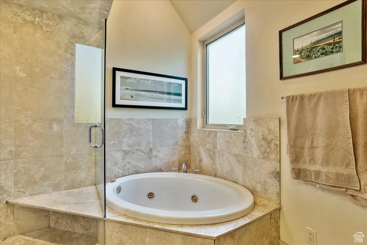 Full bathroom with a shower stall and a whirlpool tub