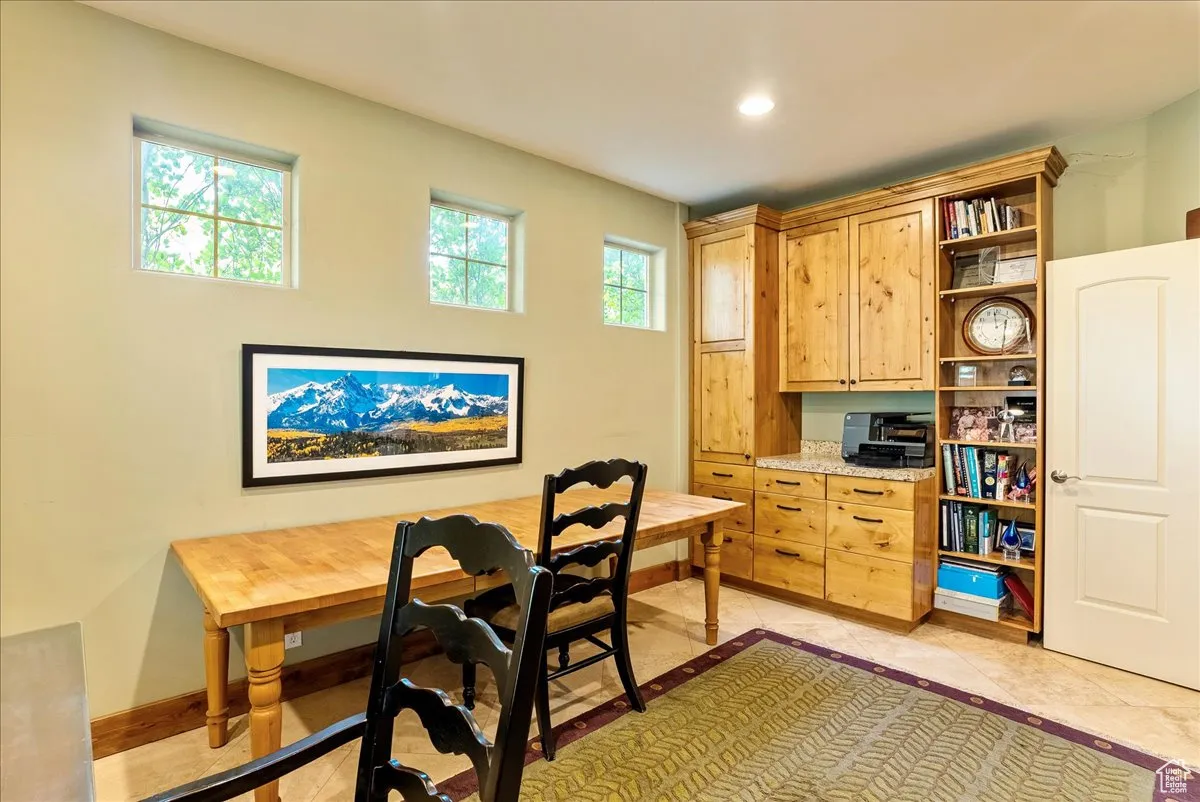 Home office with light tile patterned floors and recessed lighting