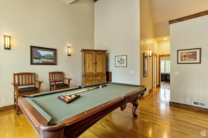 Game room featuring high vaulted ceiling, light wood-type flooring, billiards, and recessed lighting