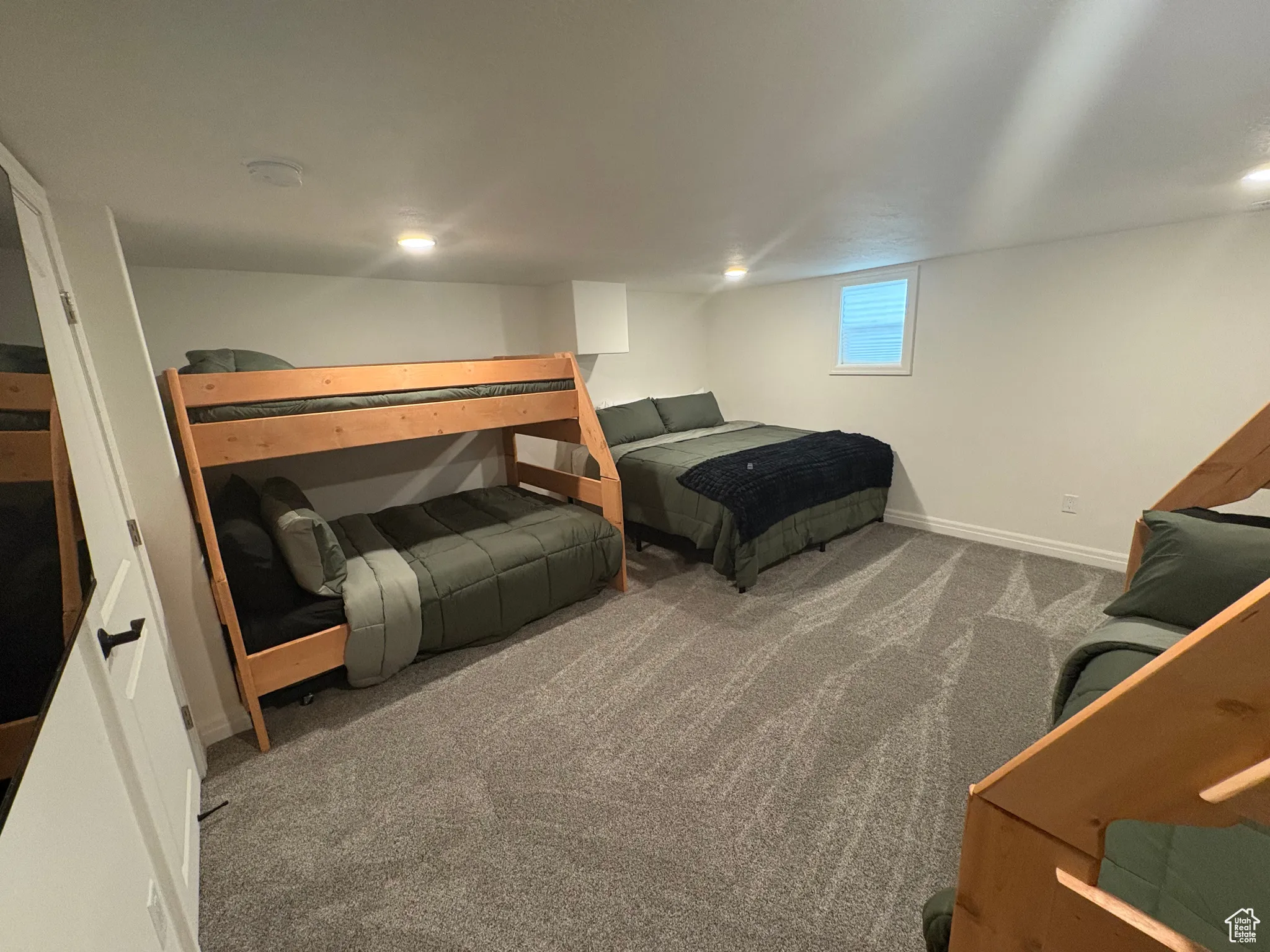 Carpeted bedroom featuring baseboards
