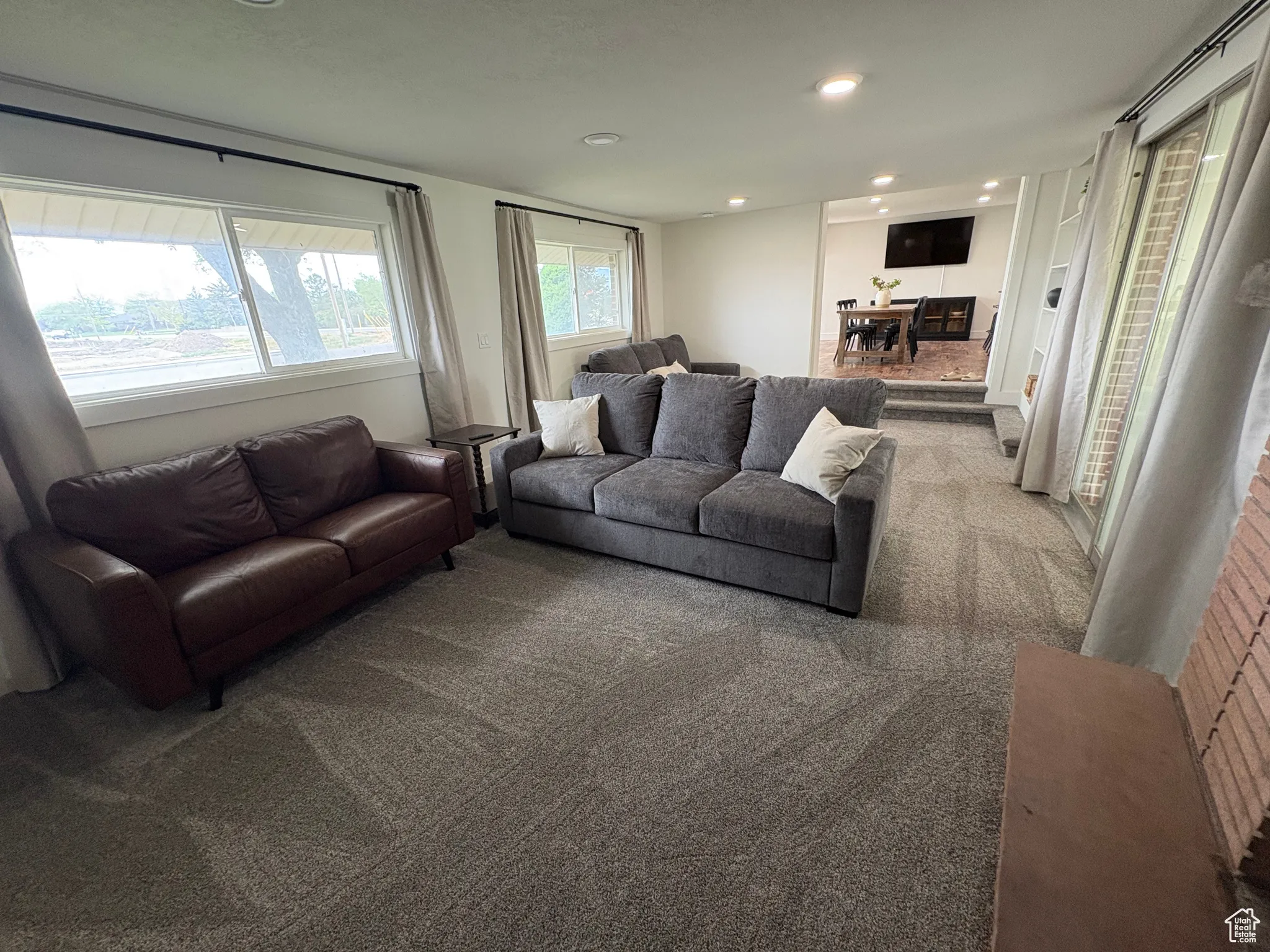 Carpeted living room featuring recessed lighting