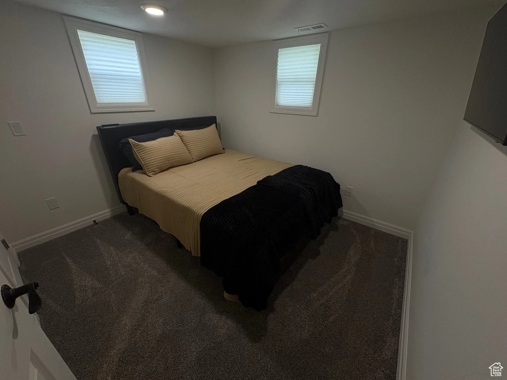 Bedroom with carpet flooring, multiple windows, and recessed lighting