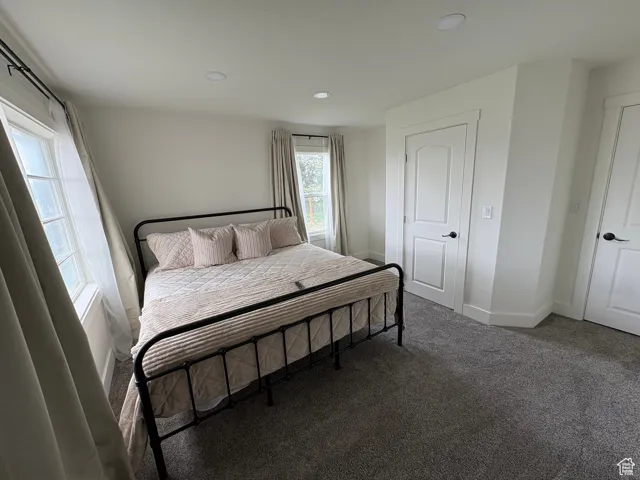 Carpeted bedroom with baseboards and recessed lighting