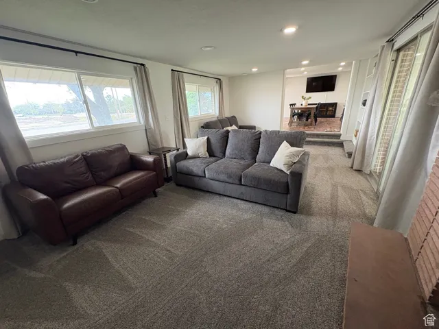 Carpeted living room featuring recessed lighting