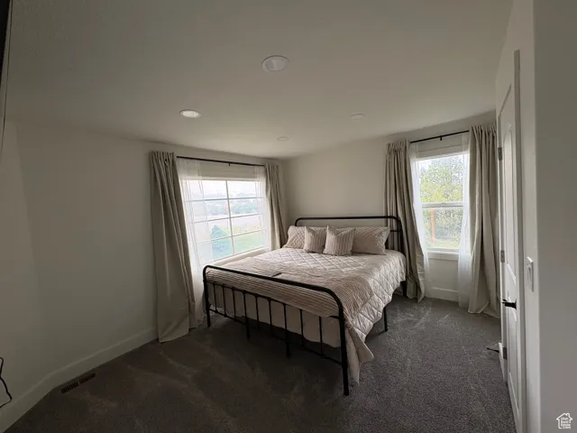 Bedroom featuring dark colored carpet and recessed lighting