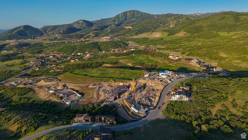 Aerial view of property's location with a mountain backdrop