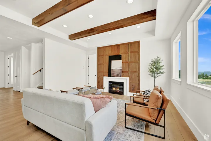 Open concept family room to kitchen with fireplace centerpiece.