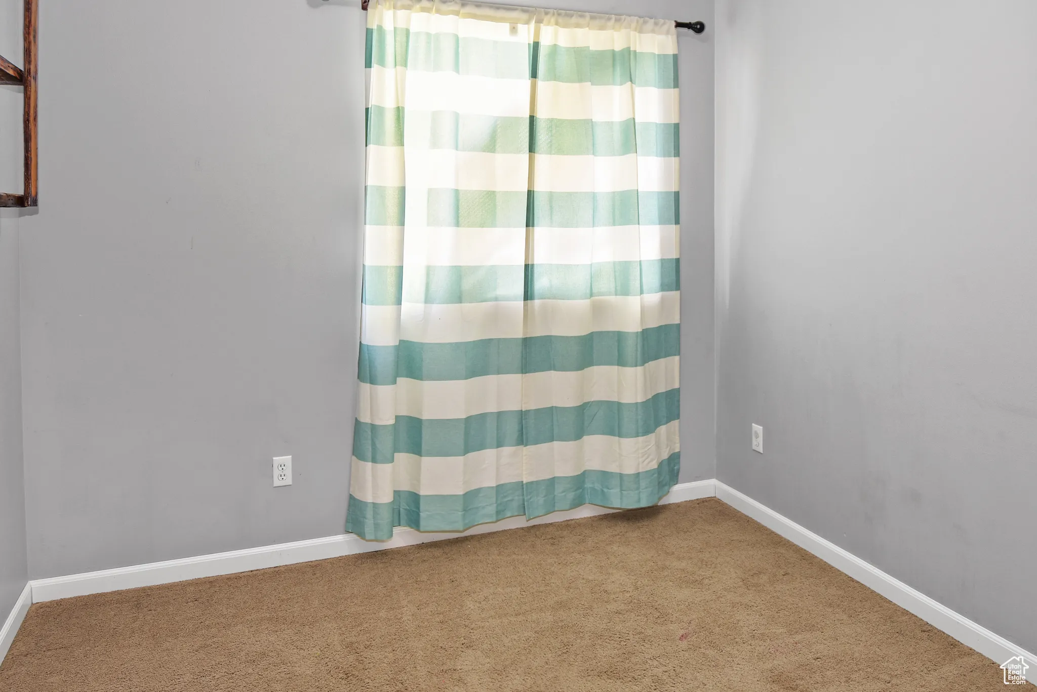 Carpeted spare room with baseboards