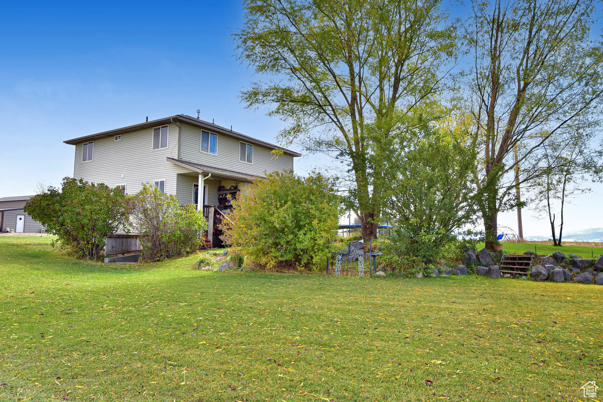 Back of house with a lawn