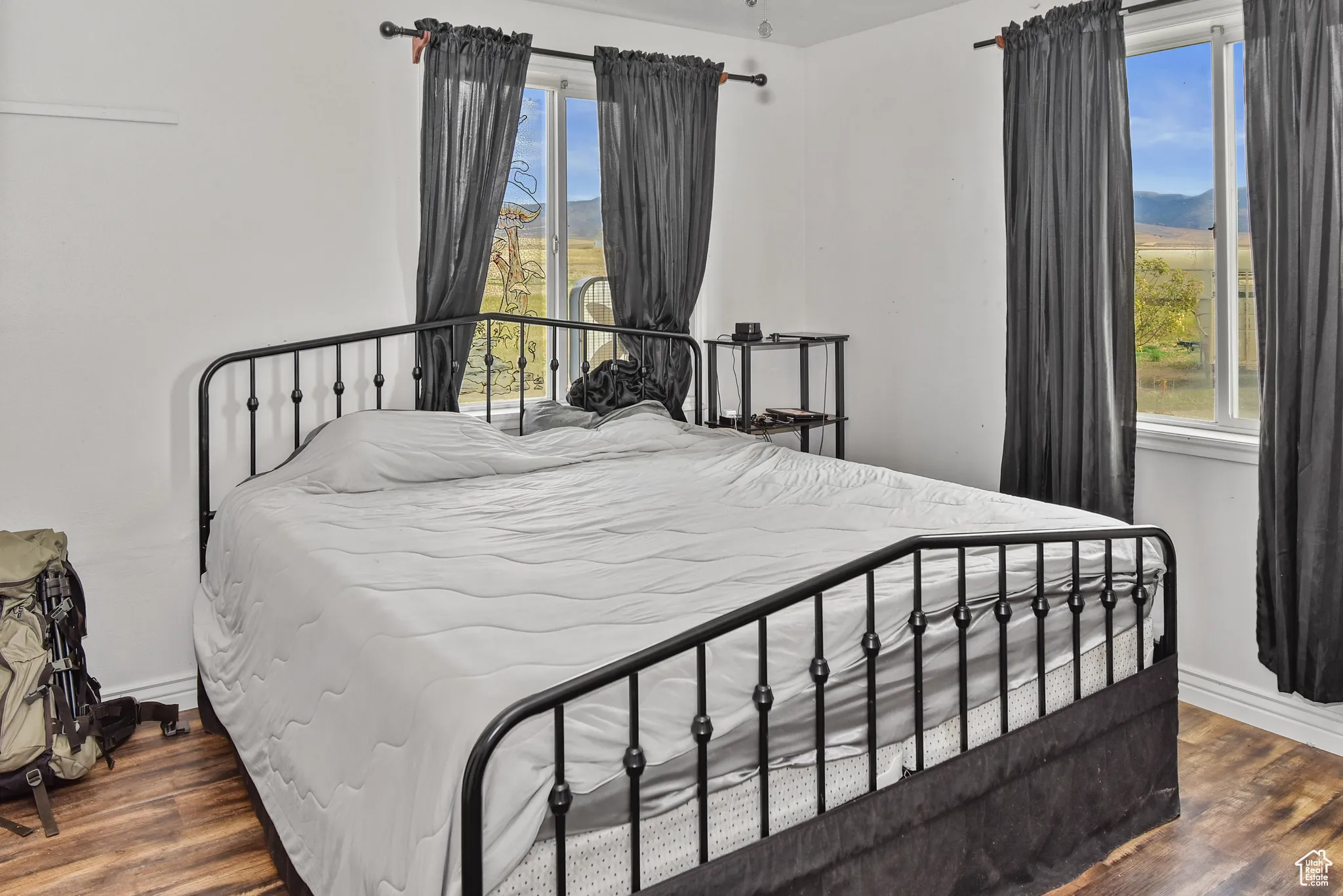 Bedroom featuring dark wood finished floors and a mountain view