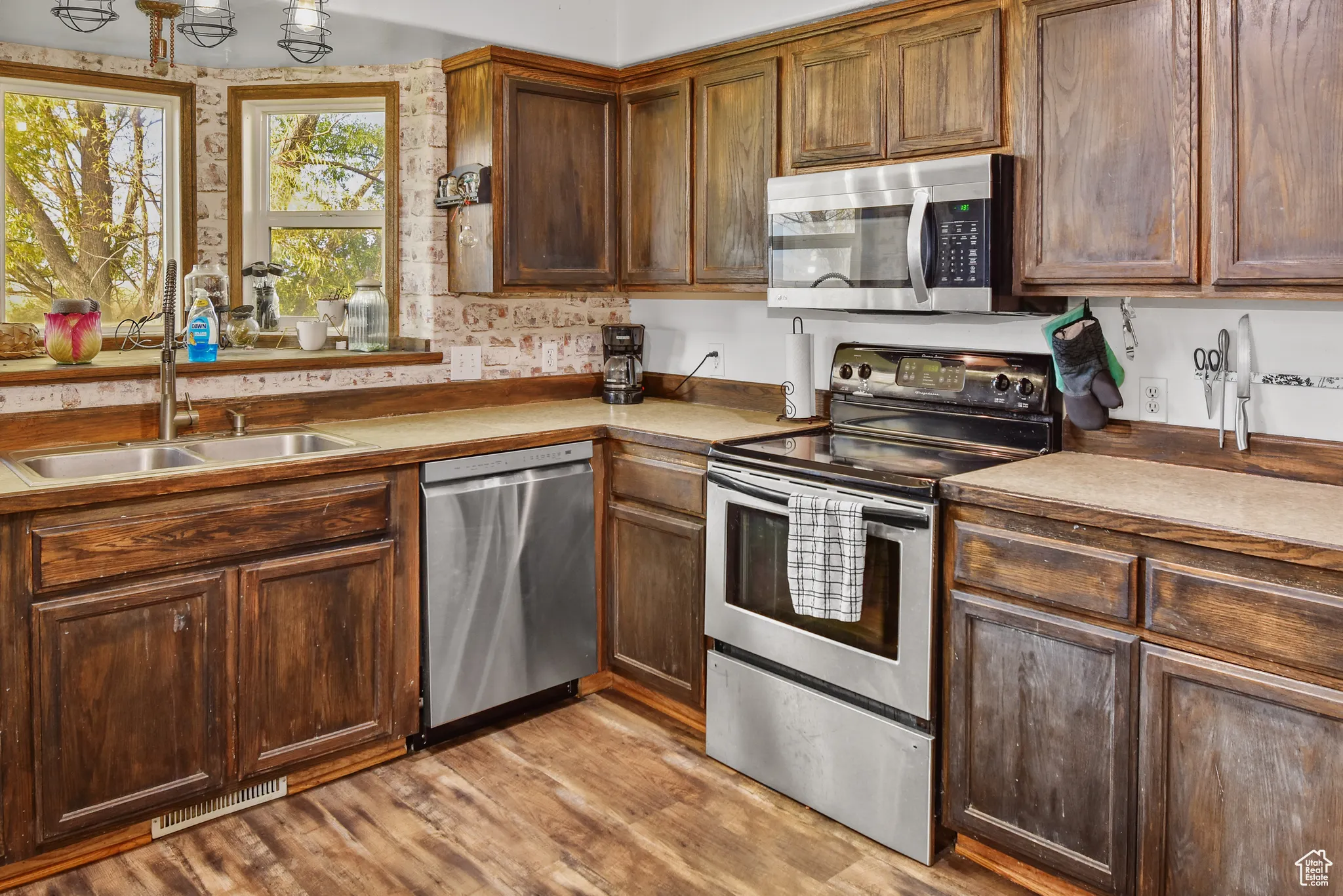 Kitchen featuring stainless steel appliances, light wood-type flooring, and light countertops