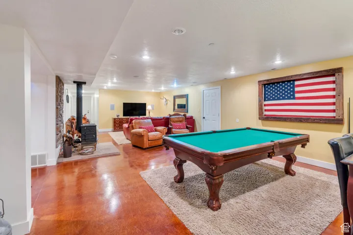Game room with a wood stove, billiards table, and recessed lighting