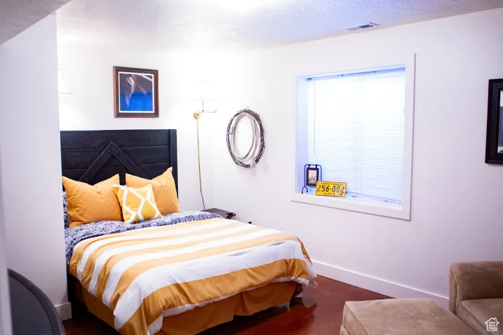 Bedroom with baseboards and a textured ceiling