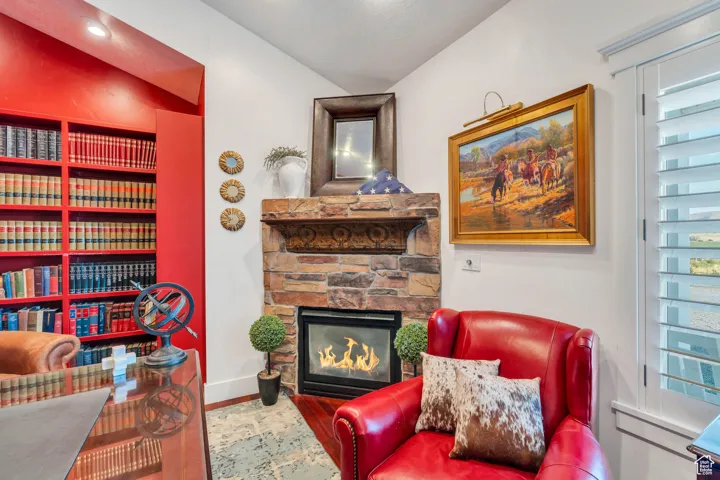 Sitting room featuring a fireplace, wood finished floors, and healthy amount of natural light