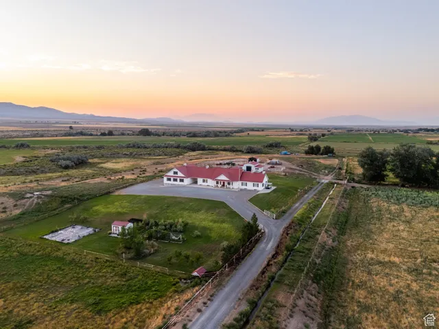 Aerial view of property's location with rural landscape and a mountain backdrop