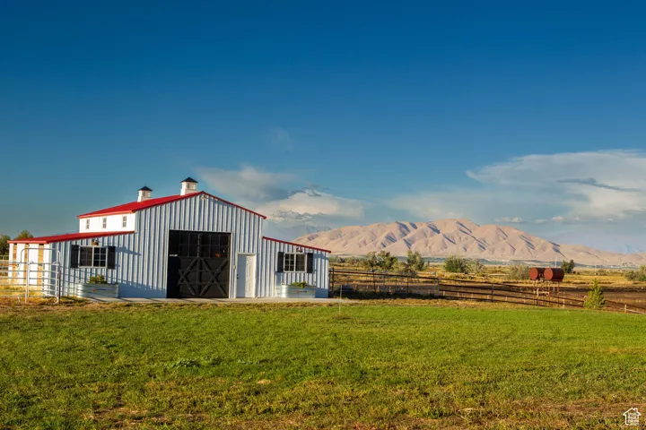 View of pole building featuring a mountain view and a view of rural / pastoral area