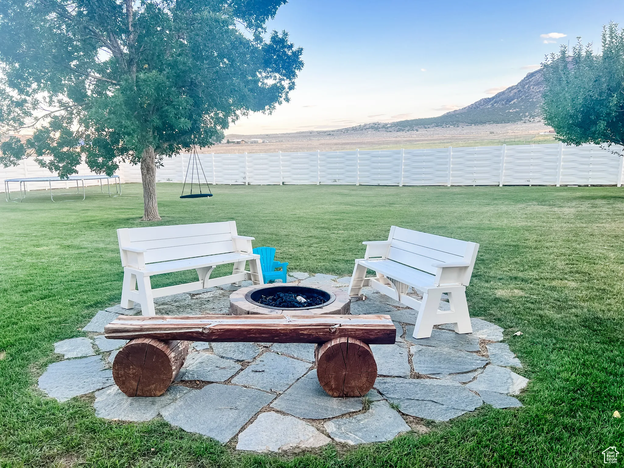 Fenced backyard with a fire pit