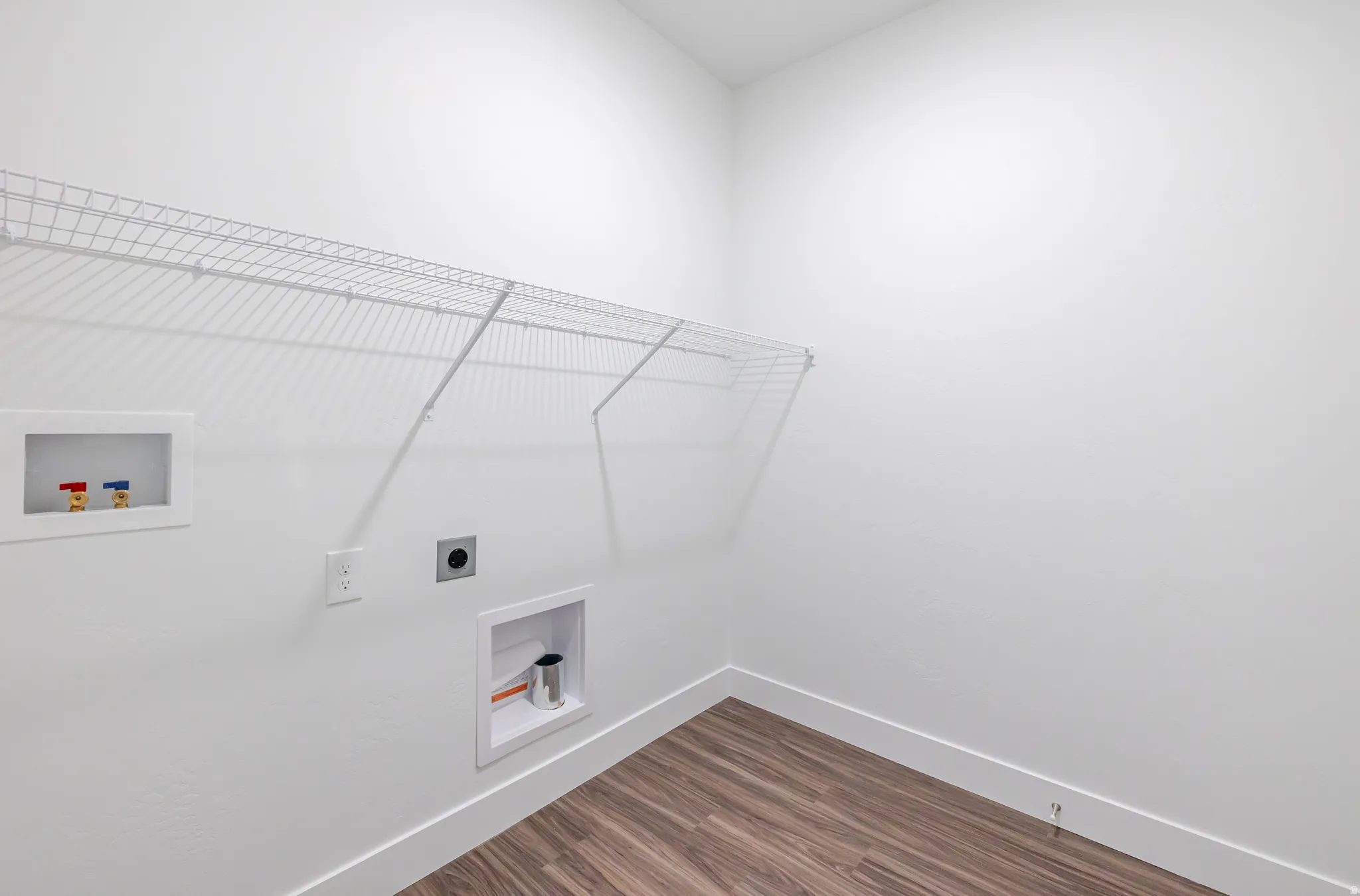 Laundry room featuring washer hookup, dark wood finished floors, and hookup for an electric dryer