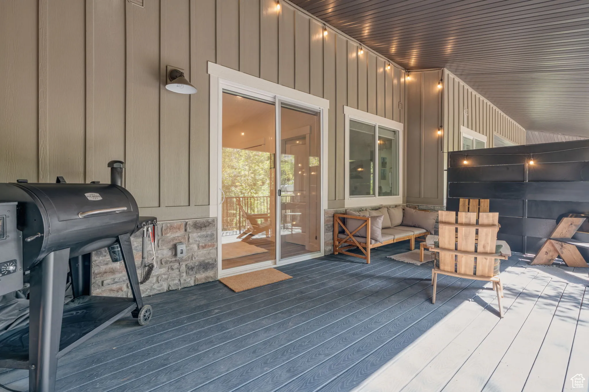 Large peaceful terrace with area for grilling and outdoor lounge area.