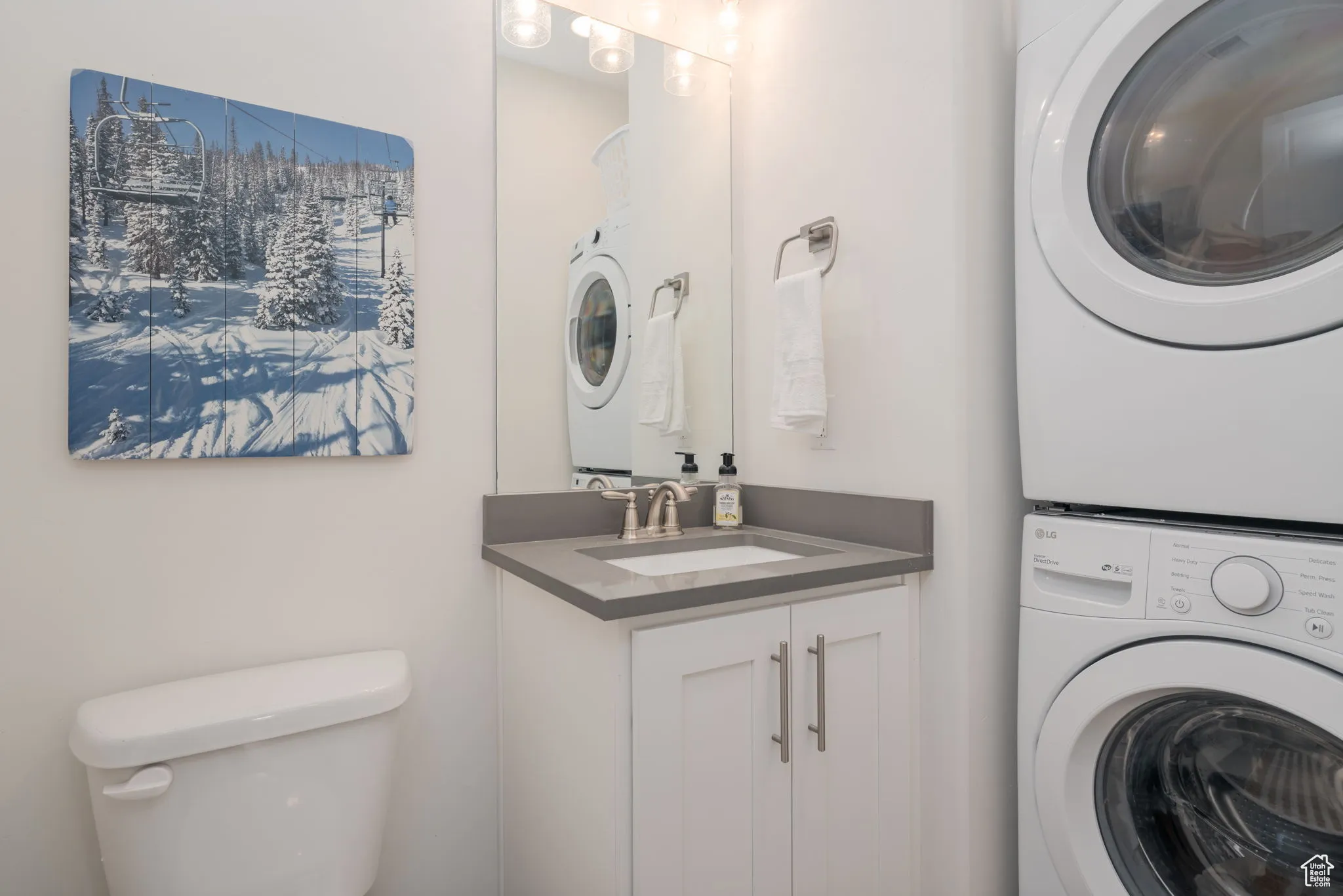 Washroom with stacked washer and dryer on the main floor