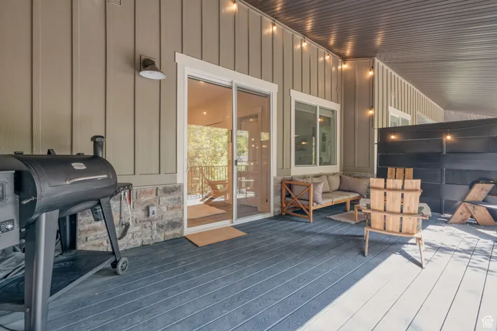 Large peaceful terrace with area for grilling and outdoor lounge area.