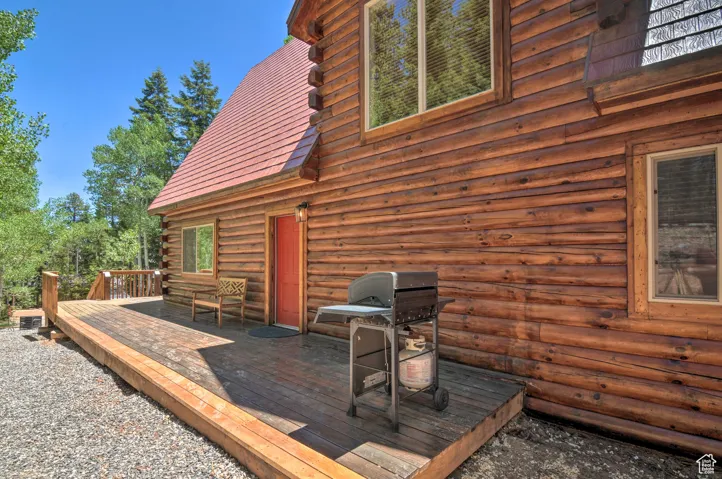 Wooden terrace featuring area for grilling