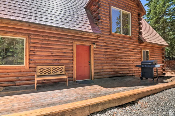 Entrance to property with a deck and log exterior