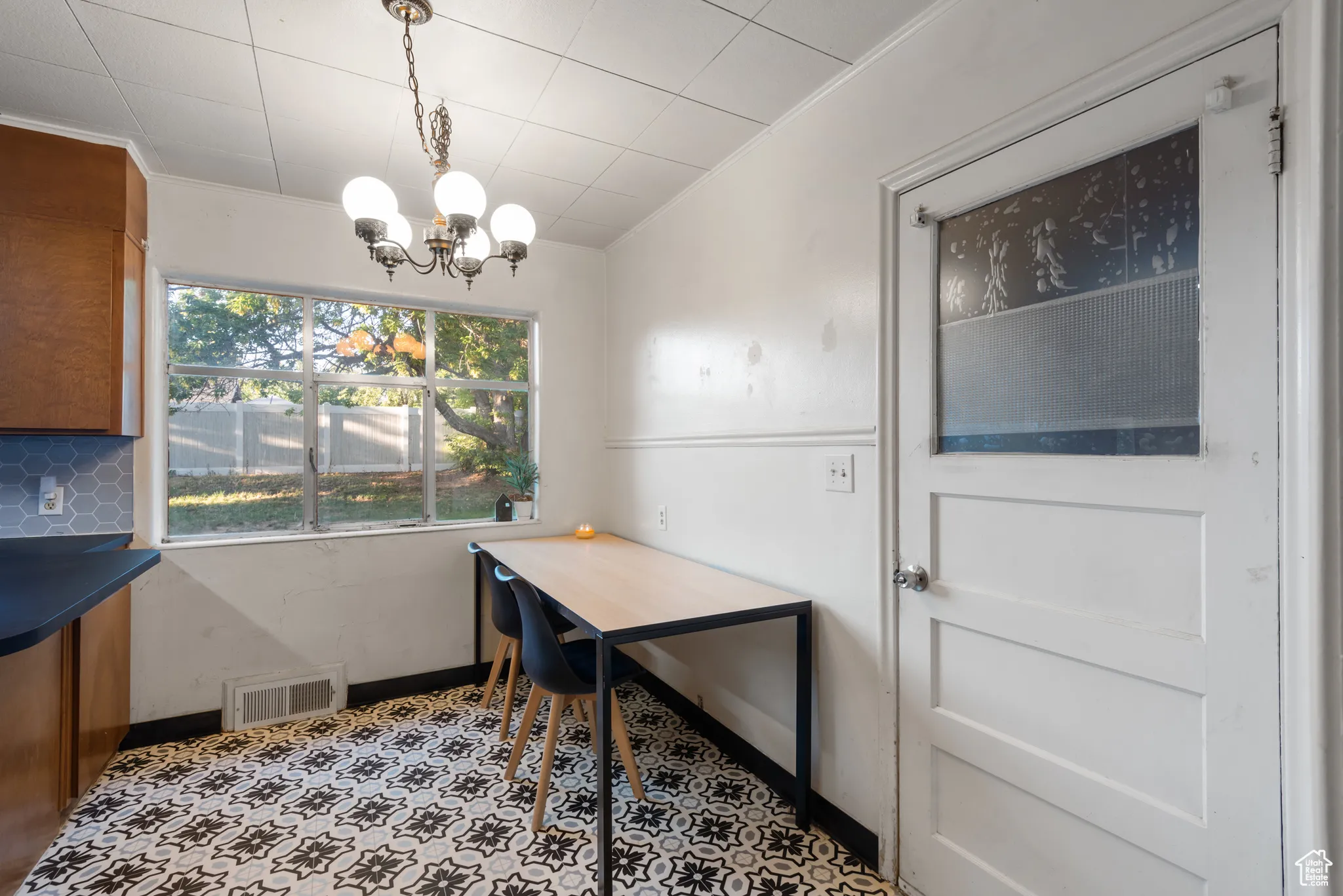 Dining area with a chandelier and baseboards