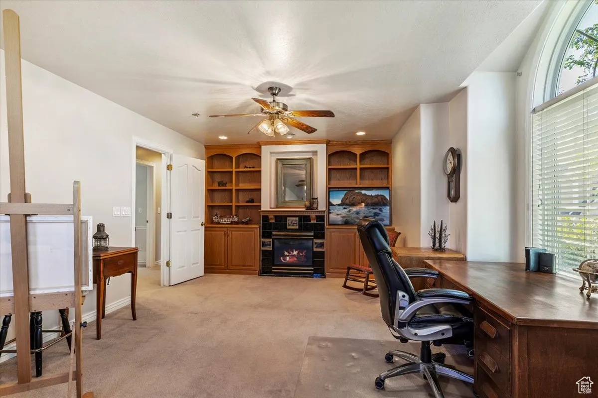 Office space with plenty of natural light, light colored carpet, a ceiling fan, and recessed lighting
