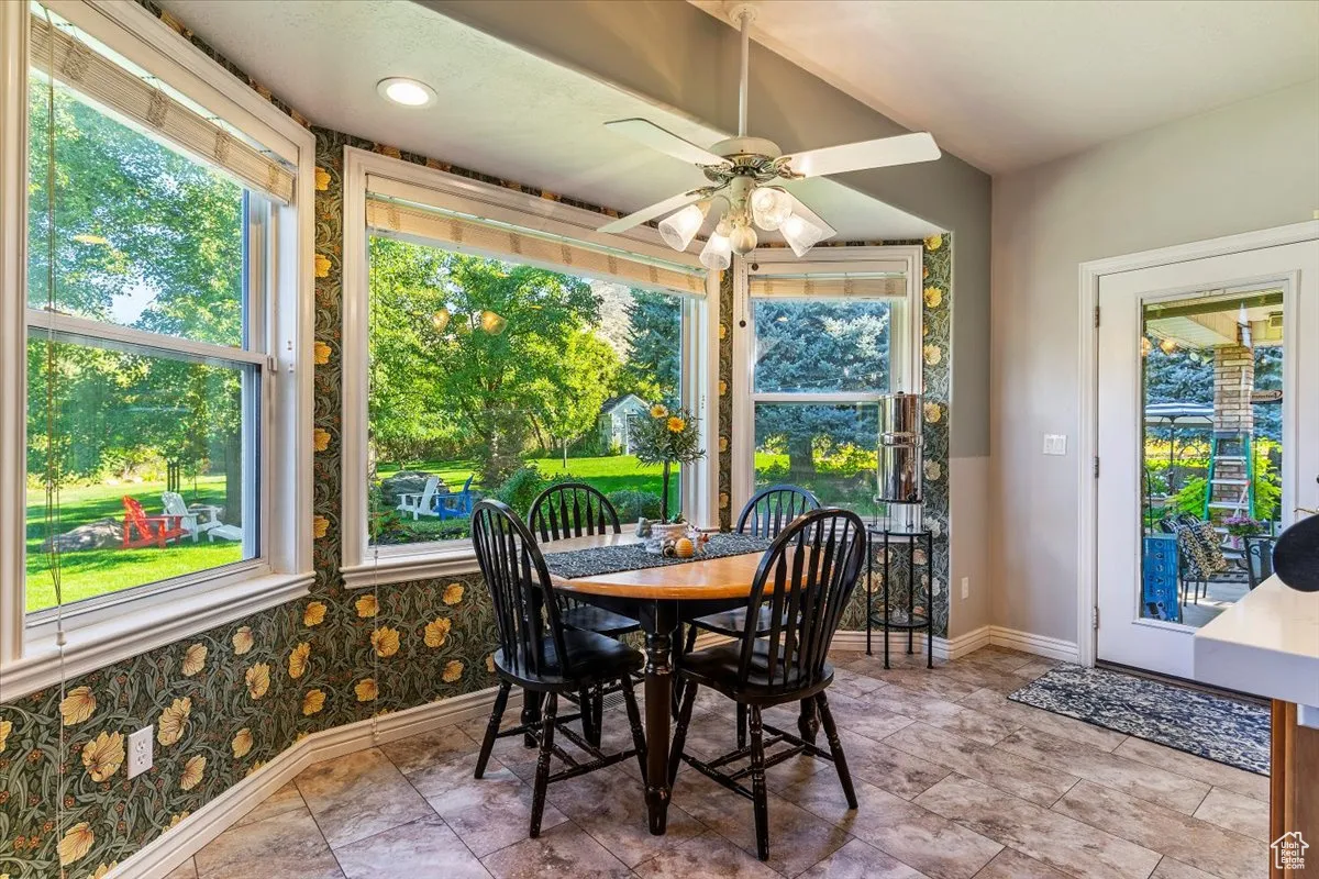 Dining space with plenty of natural light and a ceiling fan