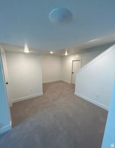 Finished basement featuring baseboards and carpet
