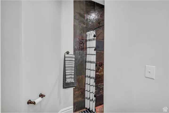 Full bath featuring a shower with shower curtain