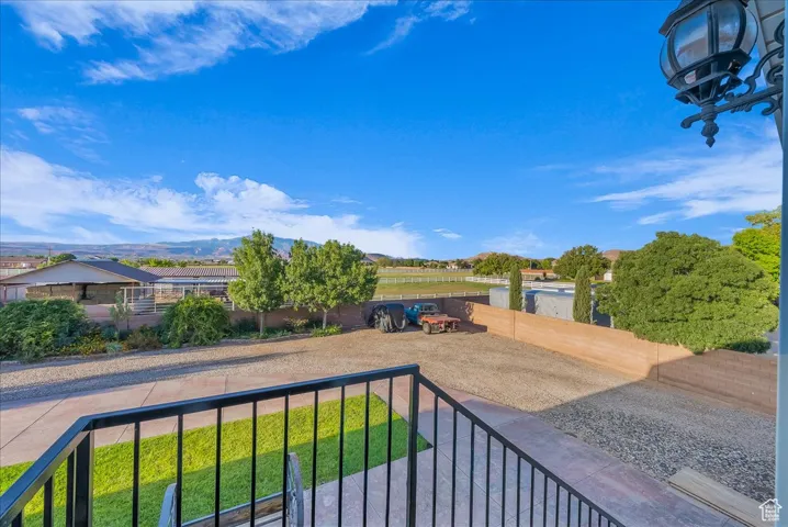 View of yard featuring a balcony and a mountain view
