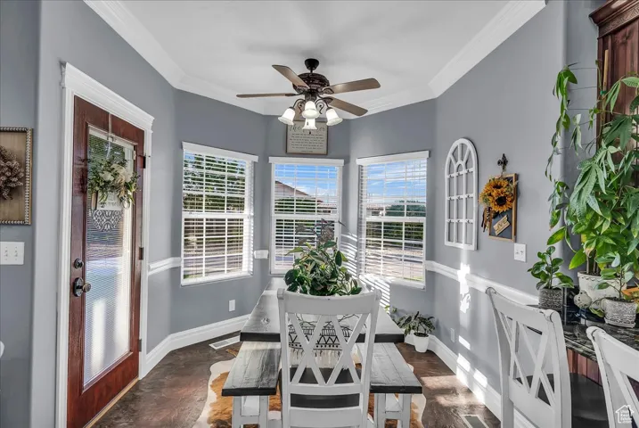 Sunroom featuring ornamental molding and baseboards