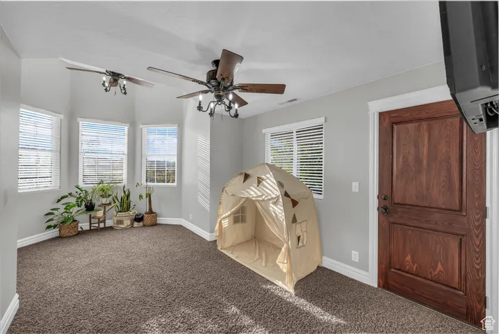 Game room featuring carpet and a ceiling fan