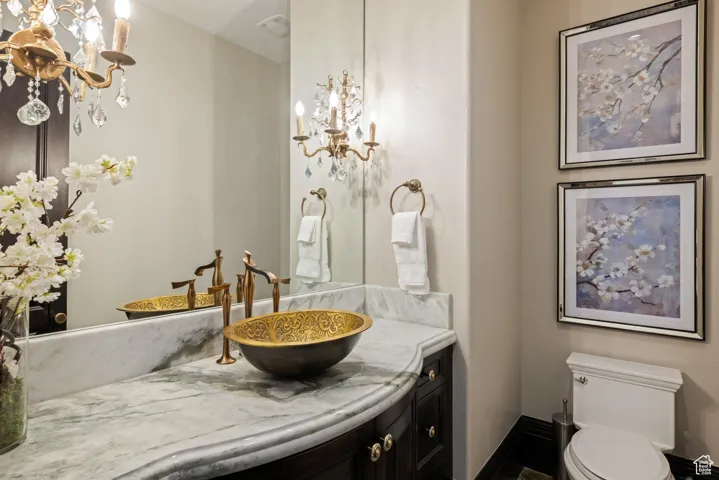 Bathroom featuring a chandelier and vanity