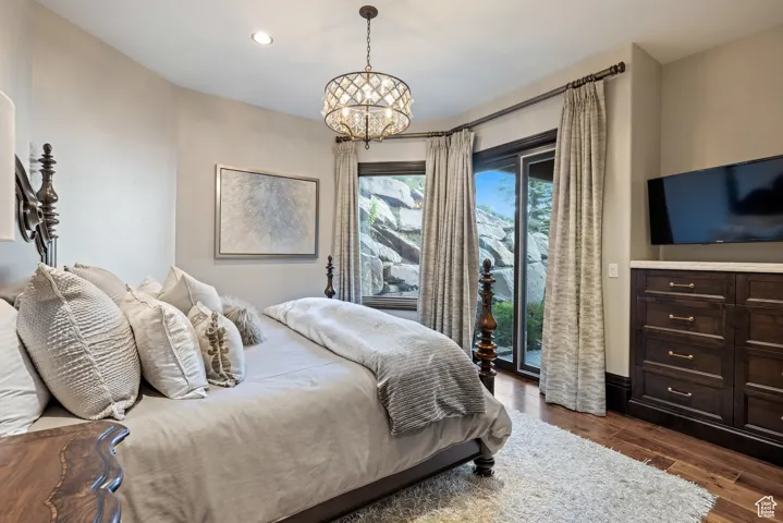 Bedroom featuring dark wood-style flooring, access to exterior, a chandelier, and recessed lighting