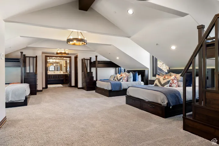 Bedroom featuring light carpet, ensuite bath, and recessed lighting