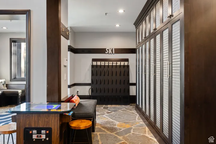 Interior space with stone flooring and recessed lighting