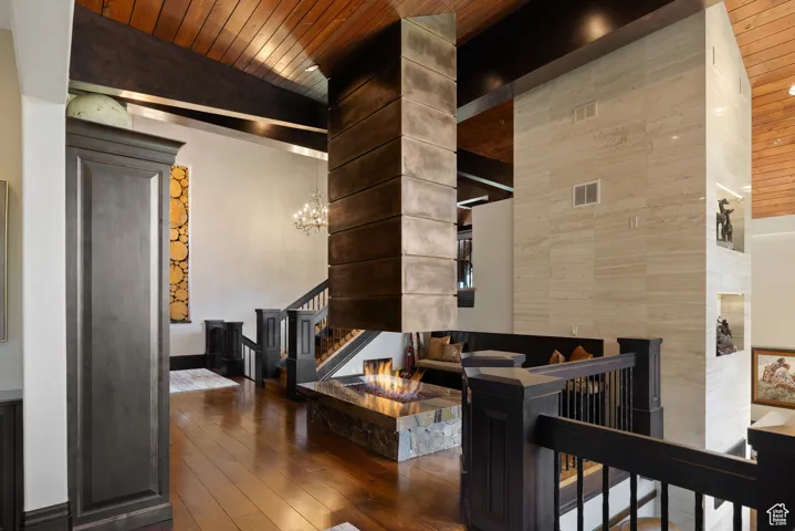 Common area with wooden ceiling, vaulted ceiling, and stairs