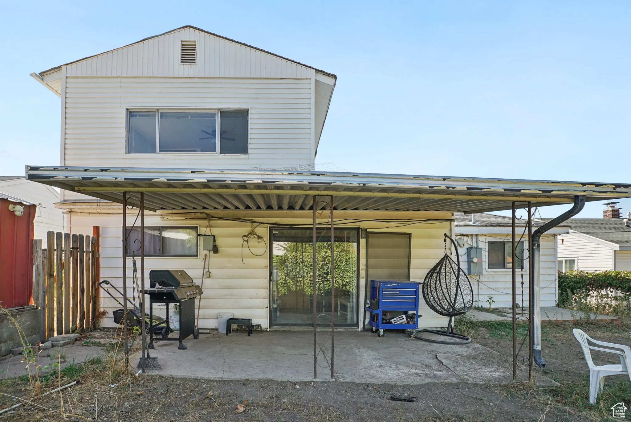 Rear view of house with a metal roof and a patio area
