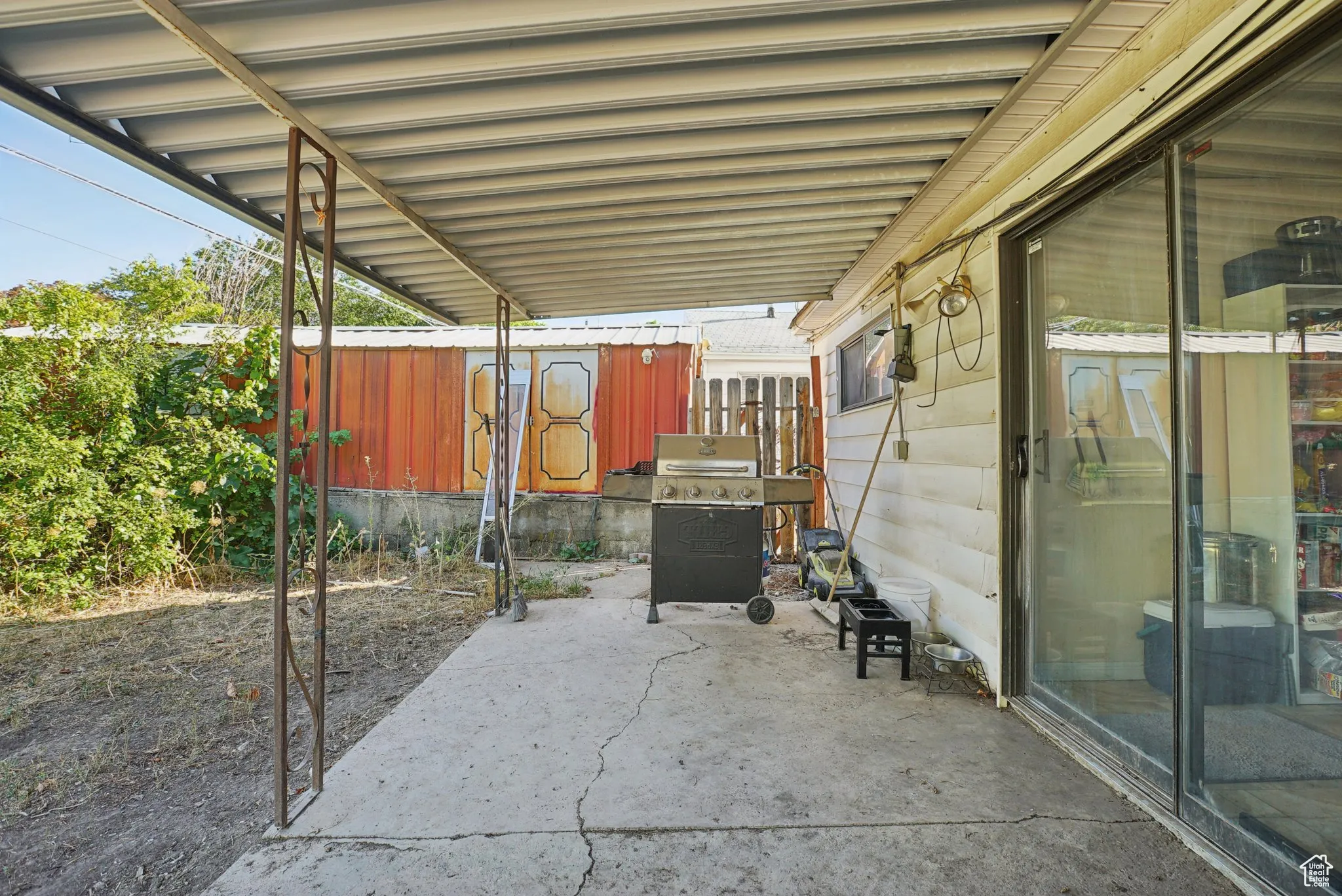 View of patio / terrace with a grill and a shed