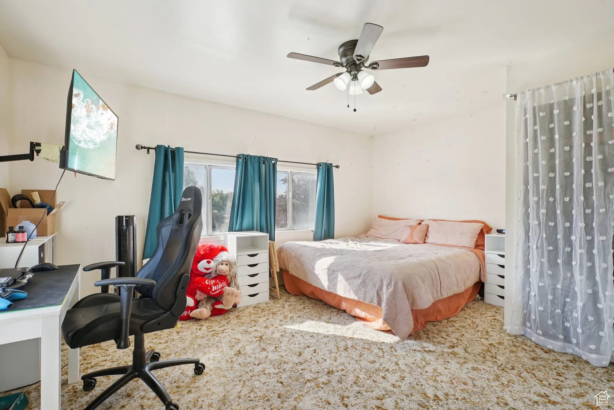 Bedroom with carpet, a ceiling fan, and an office area