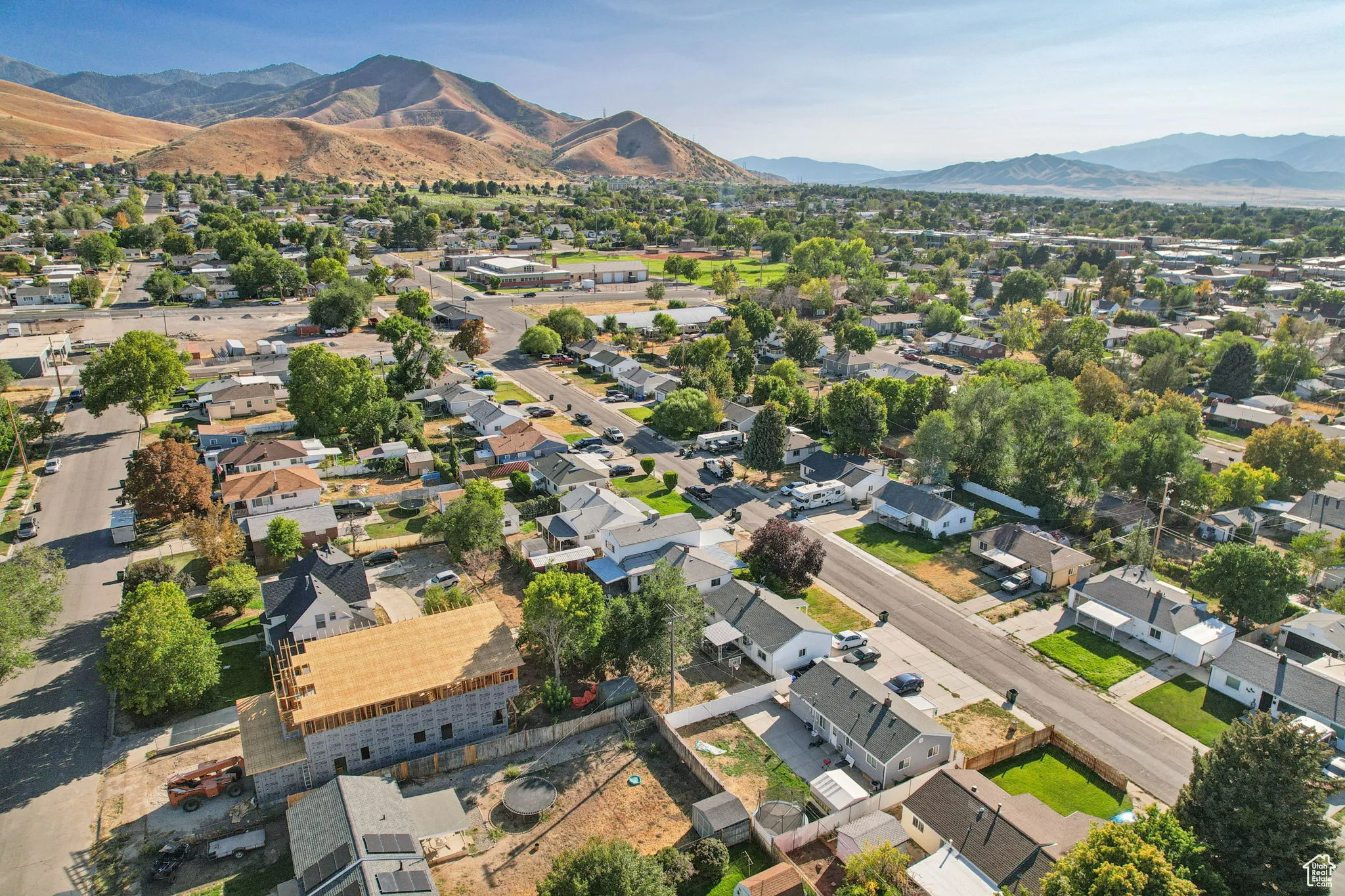 Aerial view of property's location with a mountainous background and nearby suburban area