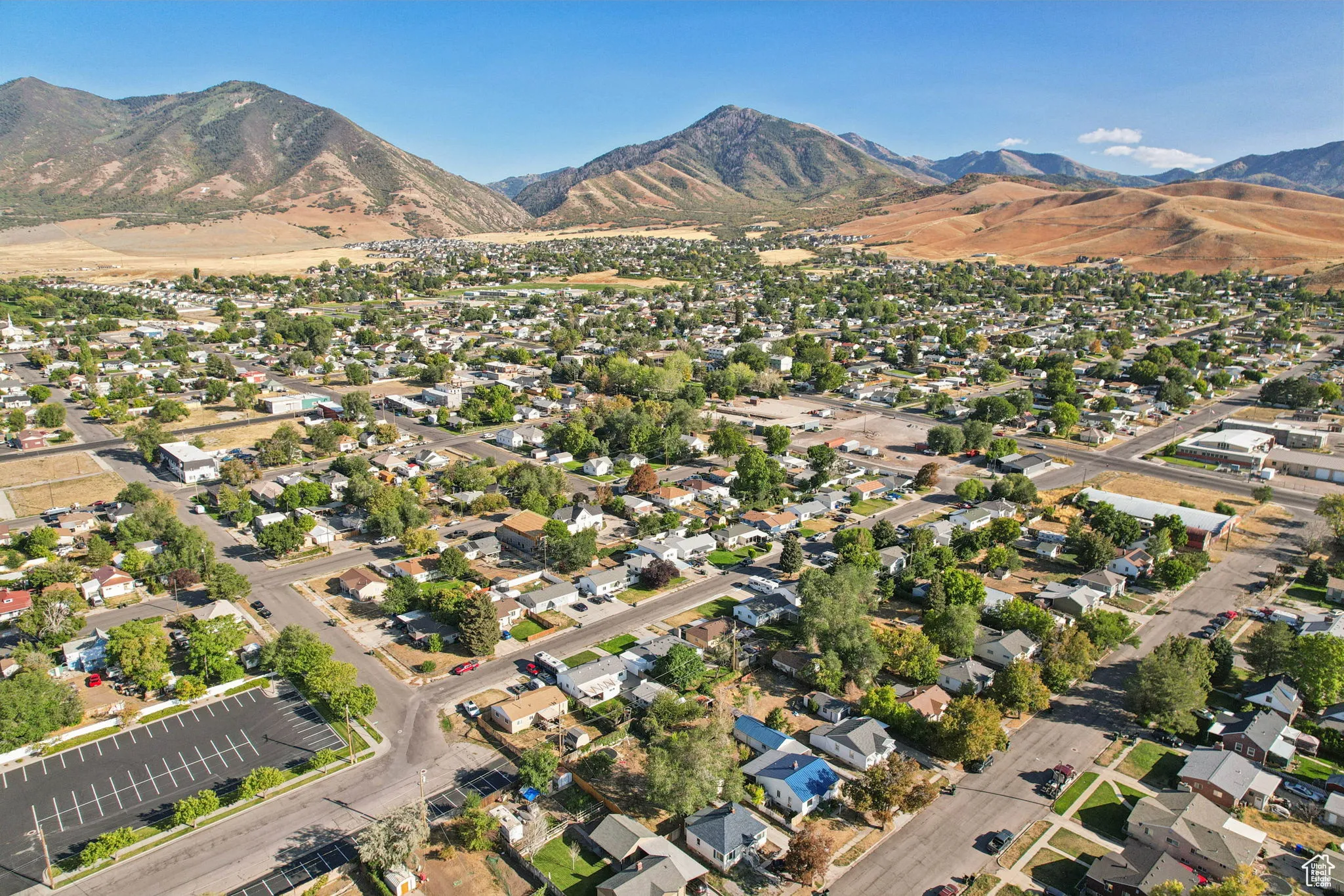 Aerial overview of property's location featuring nearby suburban area and a mountainous background