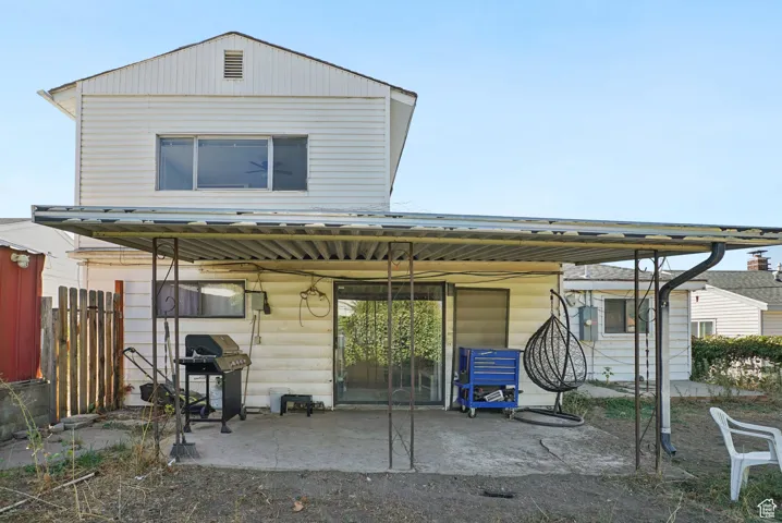 Rear view of house with a metal roof and a patio area
